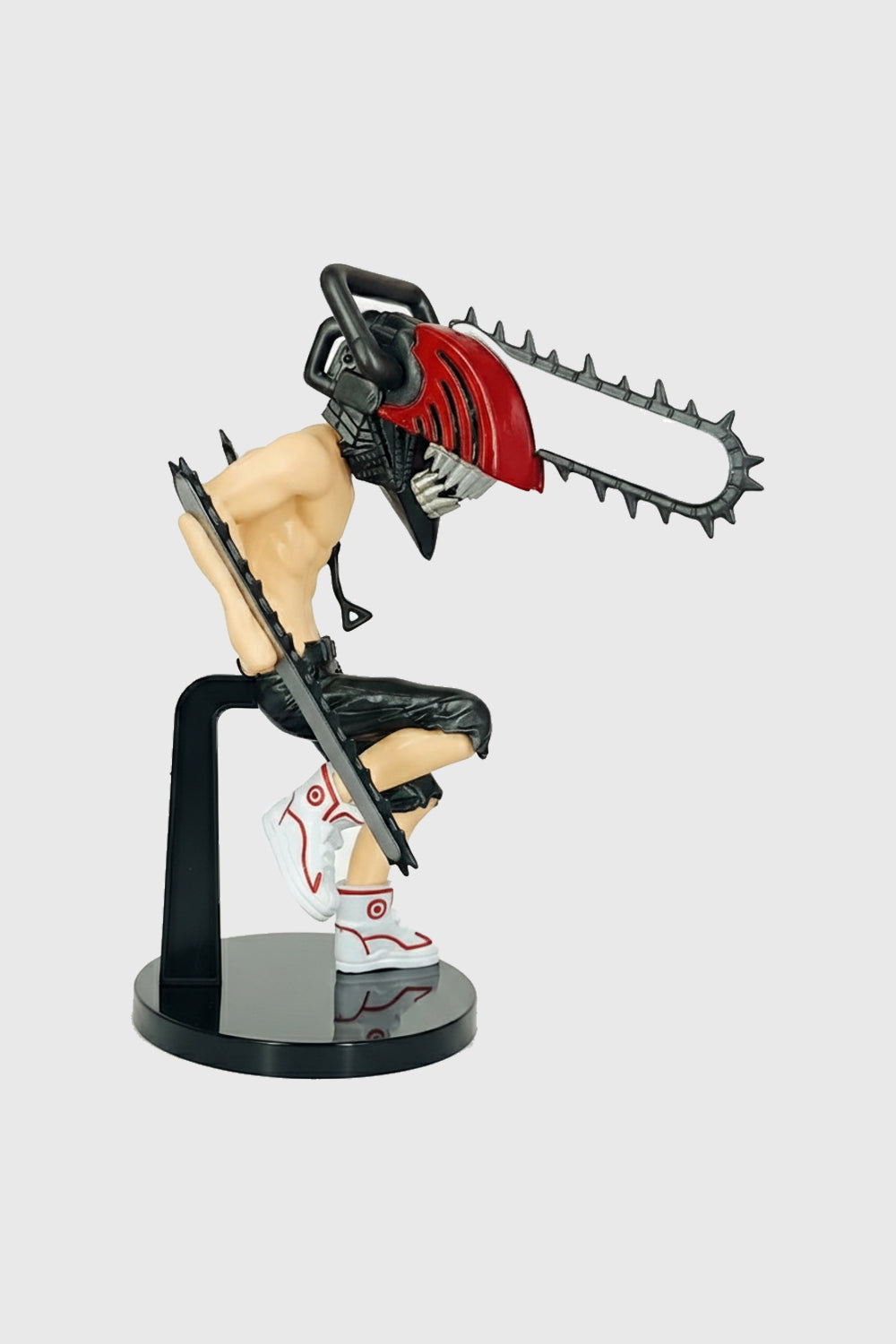 Side view of Denji anime figure showing chainsaw arms