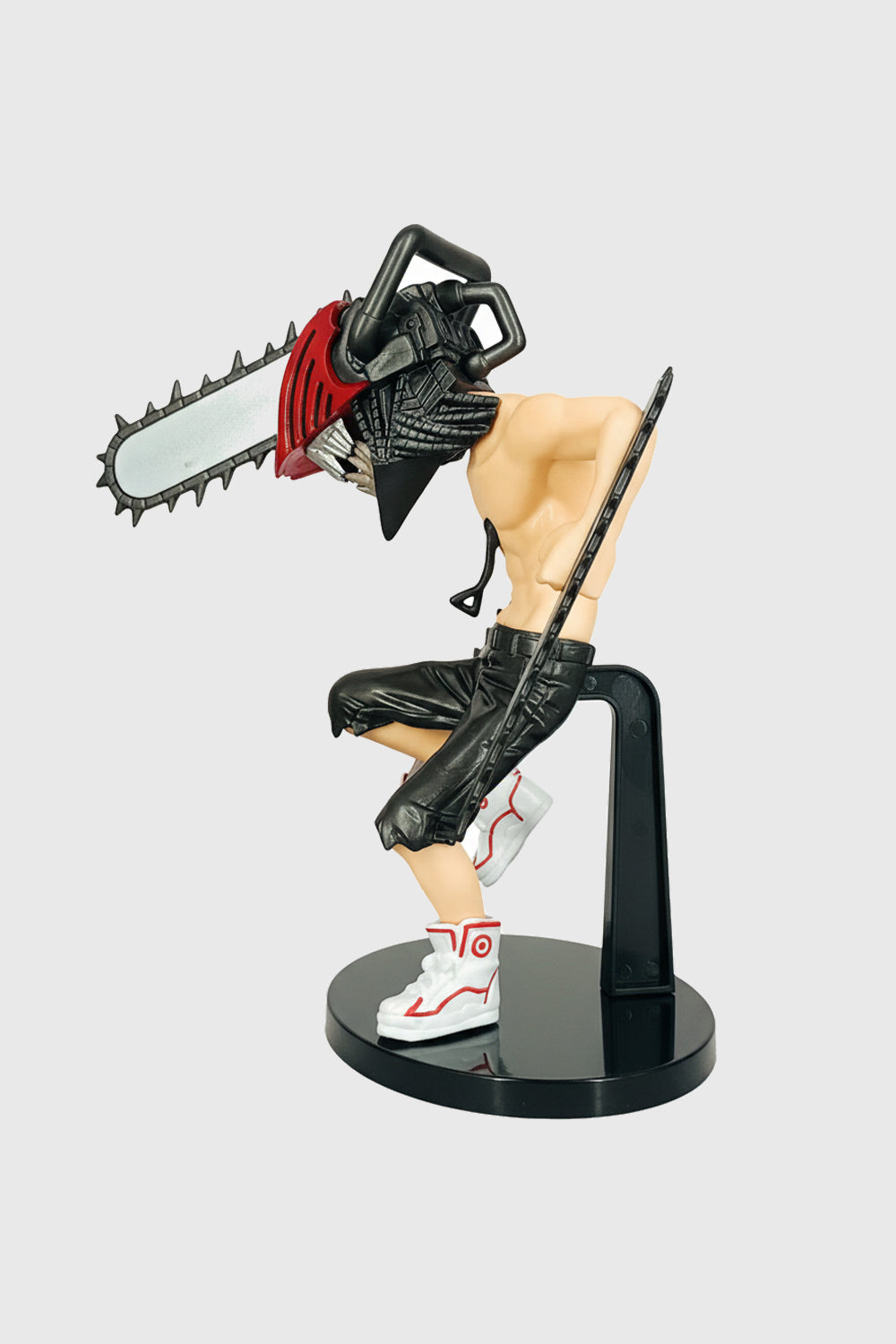 Battle-ready pose of Denji action figure with chainsaw blades