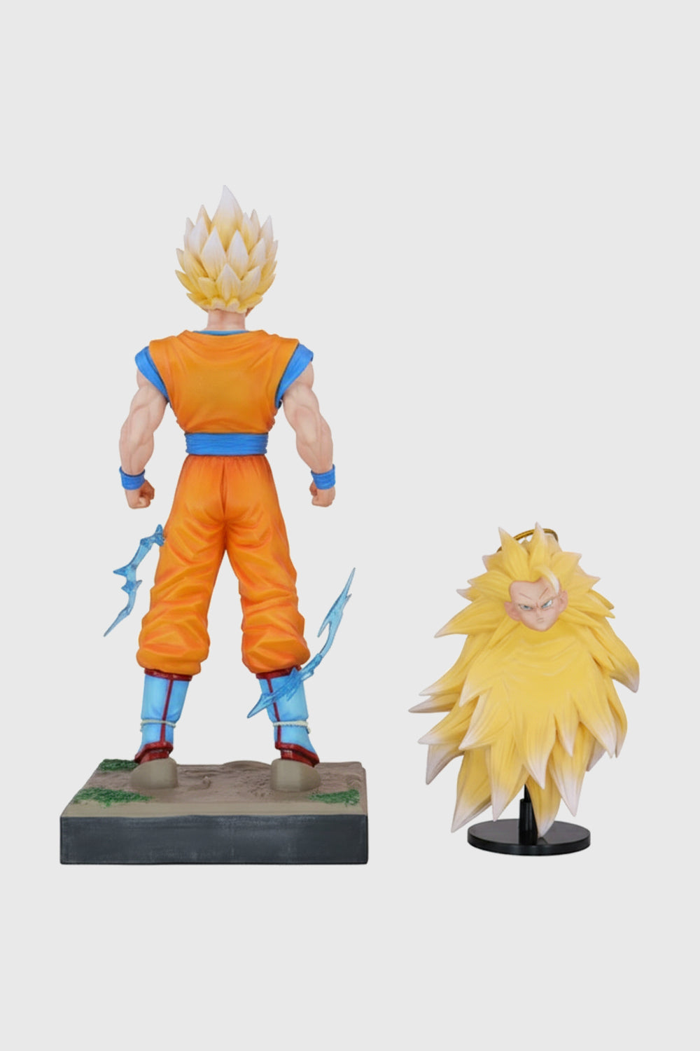 Super Saiyan Goku figure with a smaller version on a white background